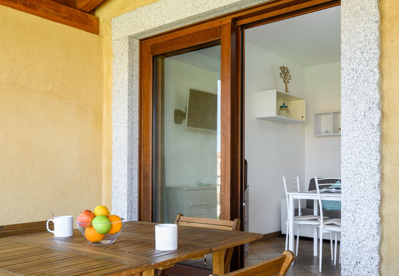 Myrsine 13/6 - Furnished veranda with table and chairs, perfect for relaxing in a holiday home in Sardinia