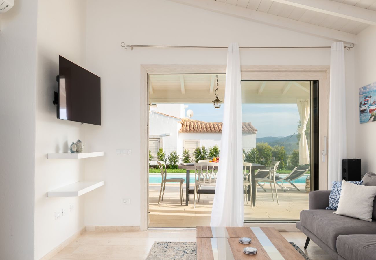 Bellevue 36E - living room with pool view in rental villa in Budoni